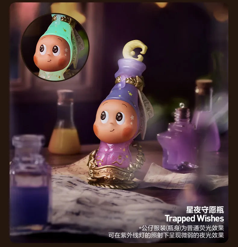 A purple collectible figure with a gold crown and green accents sits next to various glass bottles.