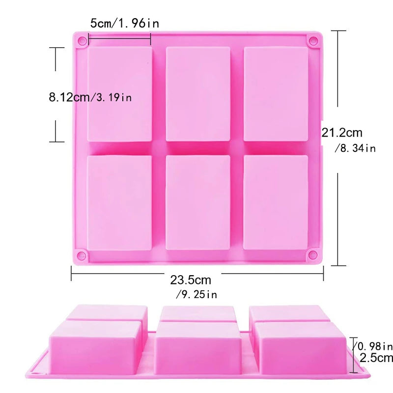 A pink silicone soap mold with six square cavities and a tray for DIY soap making.