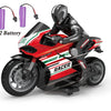 A black and red remote control stunt motorcycle toy with a rider, powered by two batteries.