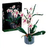 A box of Everlasting Flower Building Block Bouquet Set featuring pink and white orchid flowers.