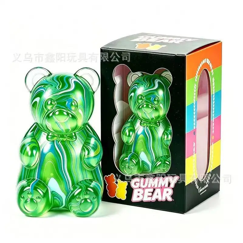 A green gummy bear squeeze toy in its original box.