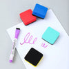 A set of two colorful magnetic whiteboard erasers made of EVA felt pads resting on a white sheet.