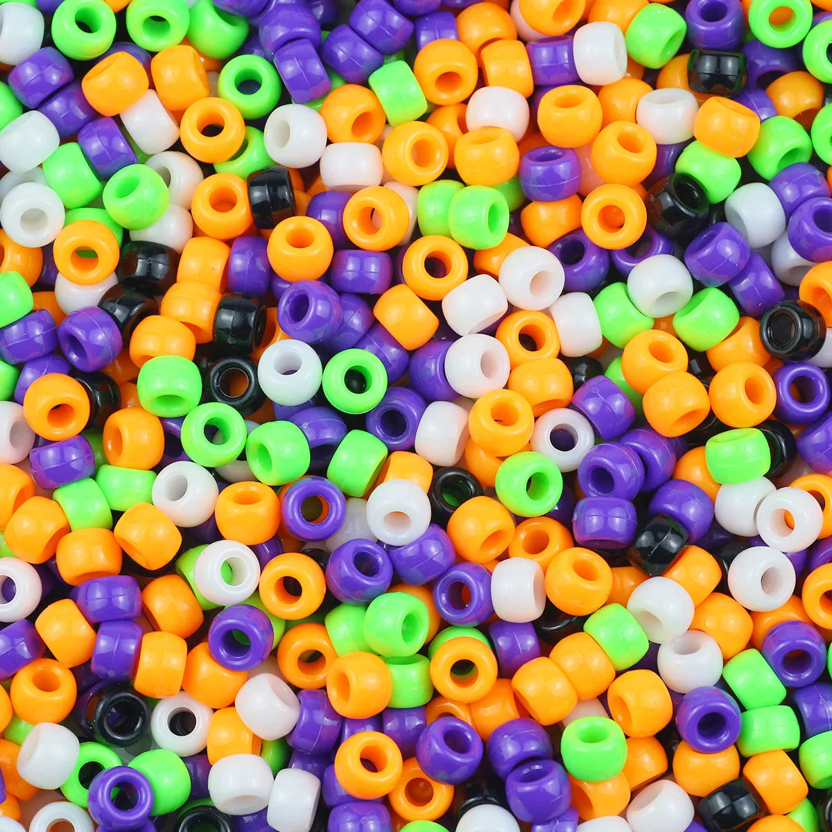 A close-up view of a pile of multicolor pony beads in various colors like green, orange, purple, and white.