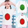 A white t-shirt featuring a red watermelon design covered in green sequins, shown on a child.