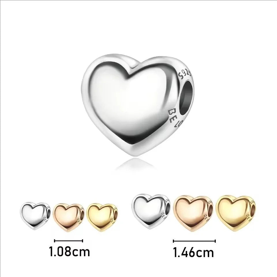 Silver heart charm with engraved letters, shown next to various size options.