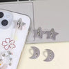Silver star-shaped phone charm hooks with adhesive backing displayed on a laptop surface.