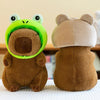 A soft brown capybara plush toy wearing a light beige hat and bright green ear coverings.