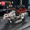 A detailed V8 engine building kit with working pistons and components displayed on a dark surface.