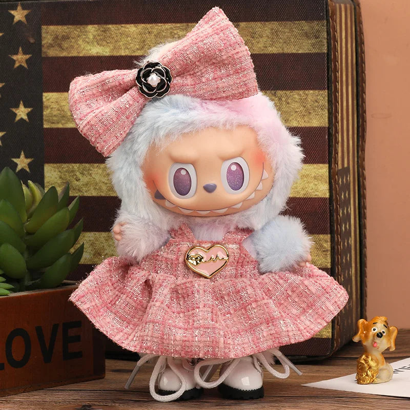 A pink flannel outfit for a 17cm Labubu doll with light blue hair and a pink bow.