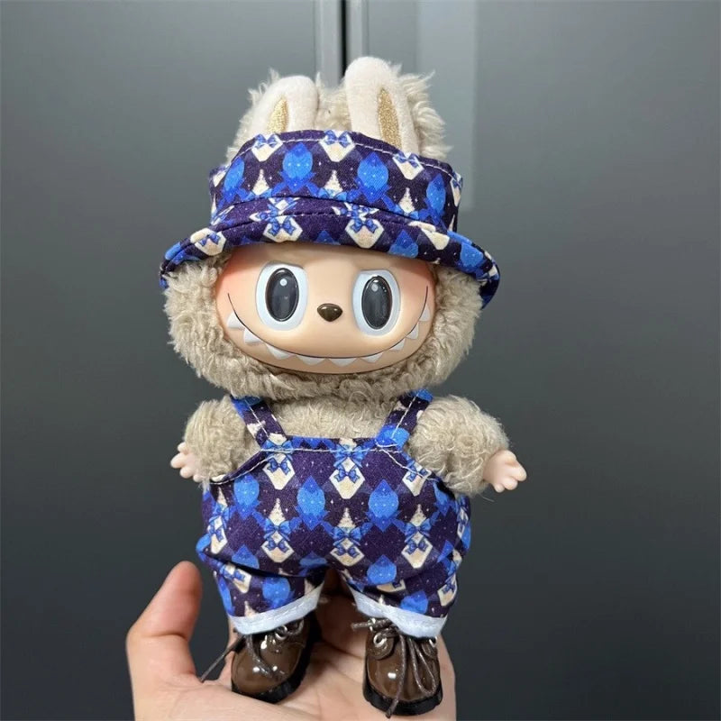Labubu doll wearing a blue and purple patterned outfit with overalls and a matching hat