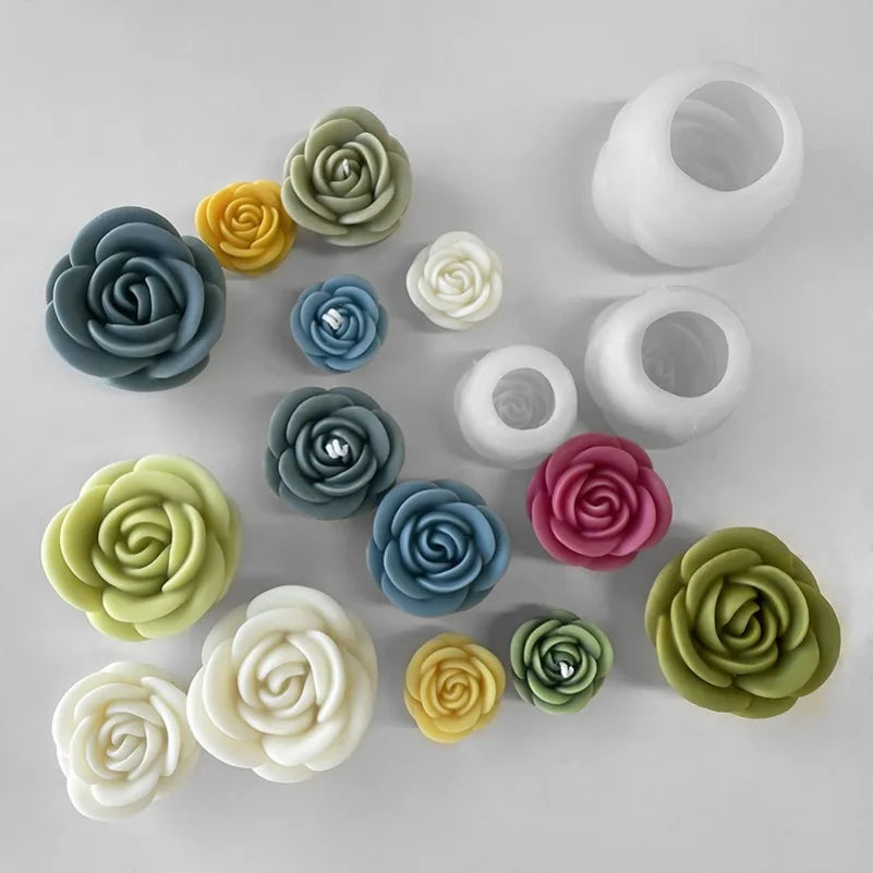 A collection of various colored 3D rose flower silicone molds for candle making, soap, and cake baking.