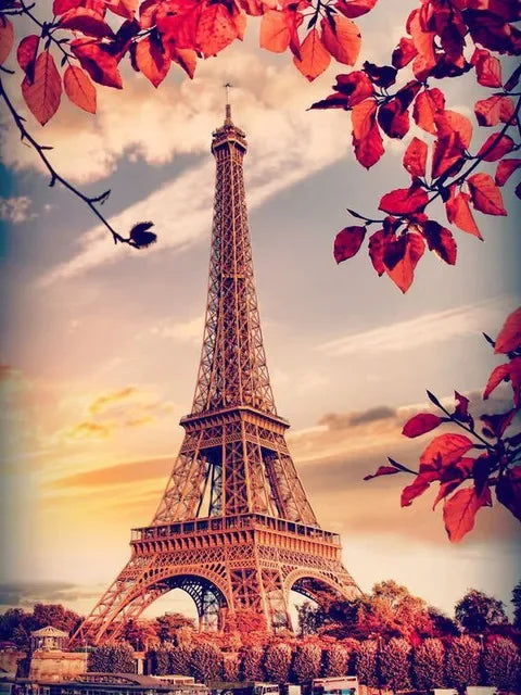 A vibrant painting of the Eiffel Tower framed by red autumn leaves against a soft sky.