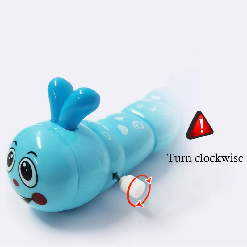 A light blue wind-up caterpillar toy with large eyes and ears, showing a mechanism for clockwise movement.