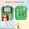 A green instant color printing camera with a dinosaur-themed design, showing examples of printed photos and accessories.