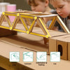 A cardboard construction kit showing a yellow truss structure being cut and folded by children.