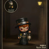 A collectible figure of a character with orange hair and dark clothing, standing in a dimly lit environment.