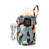 A portable baby bottle warmer in a camouflage pattern with a clear dome and power cord.