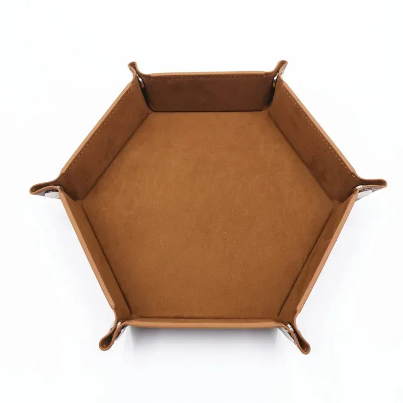 A brown hexagonal folding PU leather dice tray with a slightly raised rim.