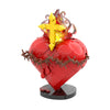 A red heart shaped building block featuring a golden cross on top, simulating the Sacred Heart of Jesus.