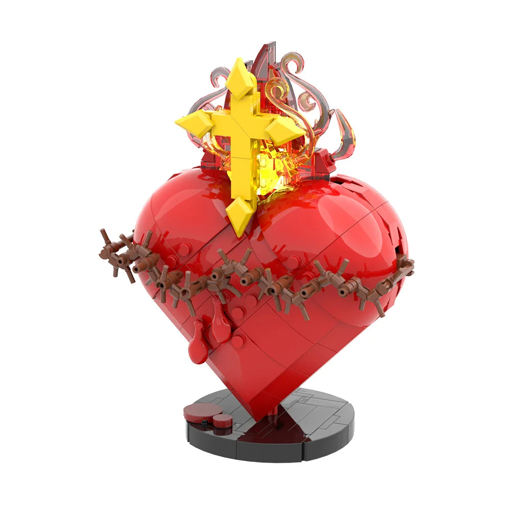 A red heart shaped building block featuring a golden cross on top, simulating the Sacred Heart of Jesus.