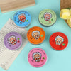 A collection of six round glass slime stress relief fidget toys in various colors and designs resting on a light blue surface