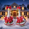 A white goose with red festive clothing stands in a snowy outdoor setting in front of a house.