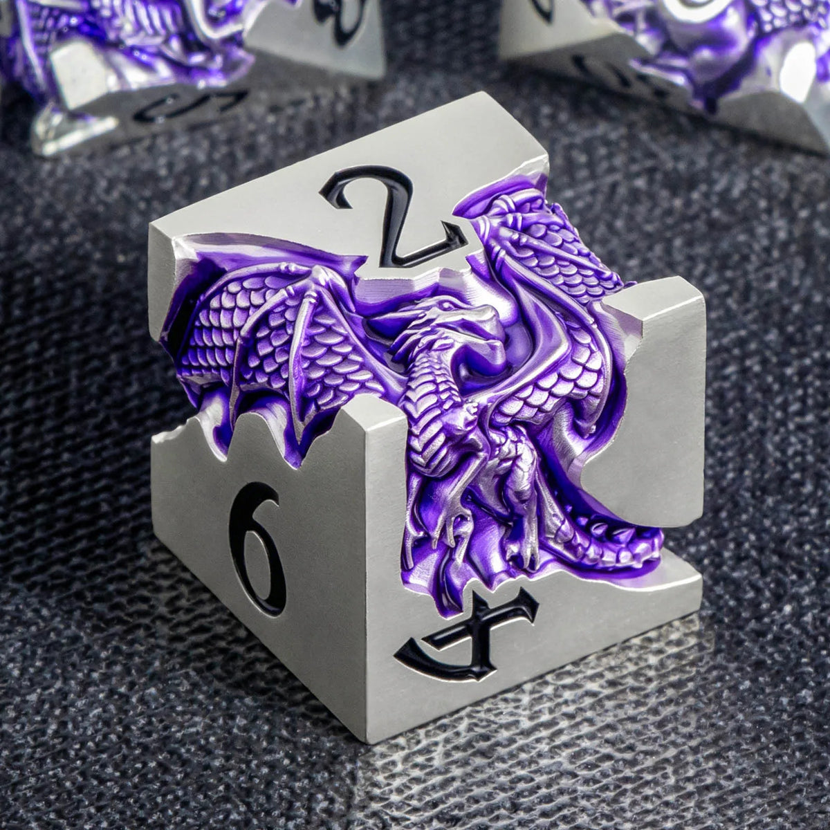 A silver metal die featuring a purple dragon design and the number 6, set against a dark background.