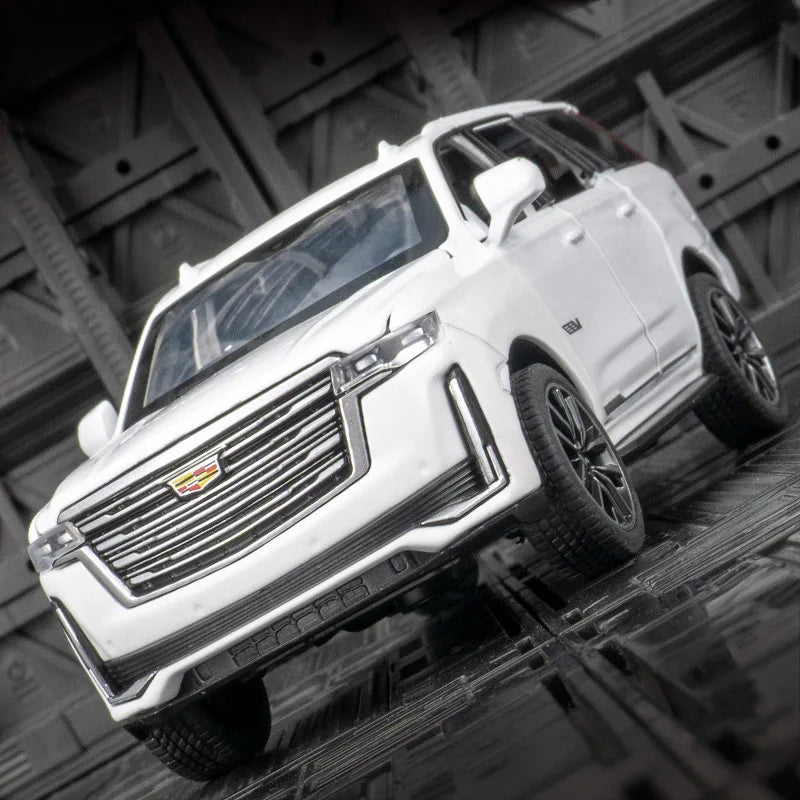 A white 1:32 scale diecast Cadillac Escalade pull-back model car is shown in a dynamic angle.
