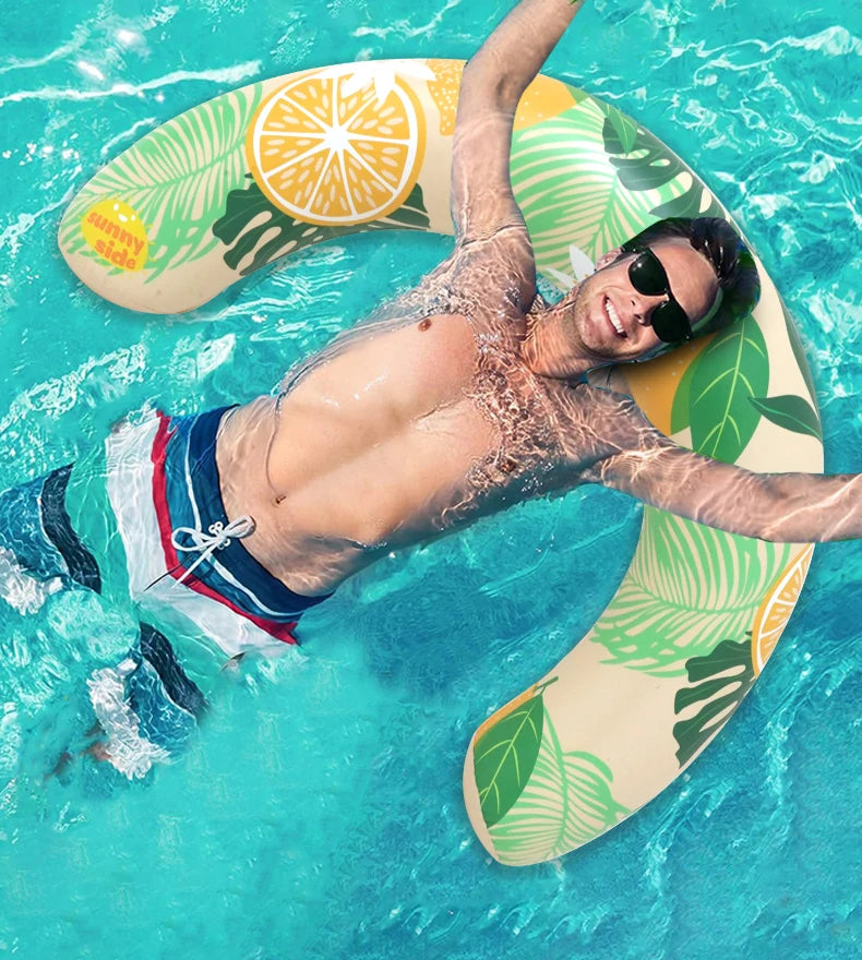 A man is floating on a yellow inflatable U-shaped swim ring in clear blue water.