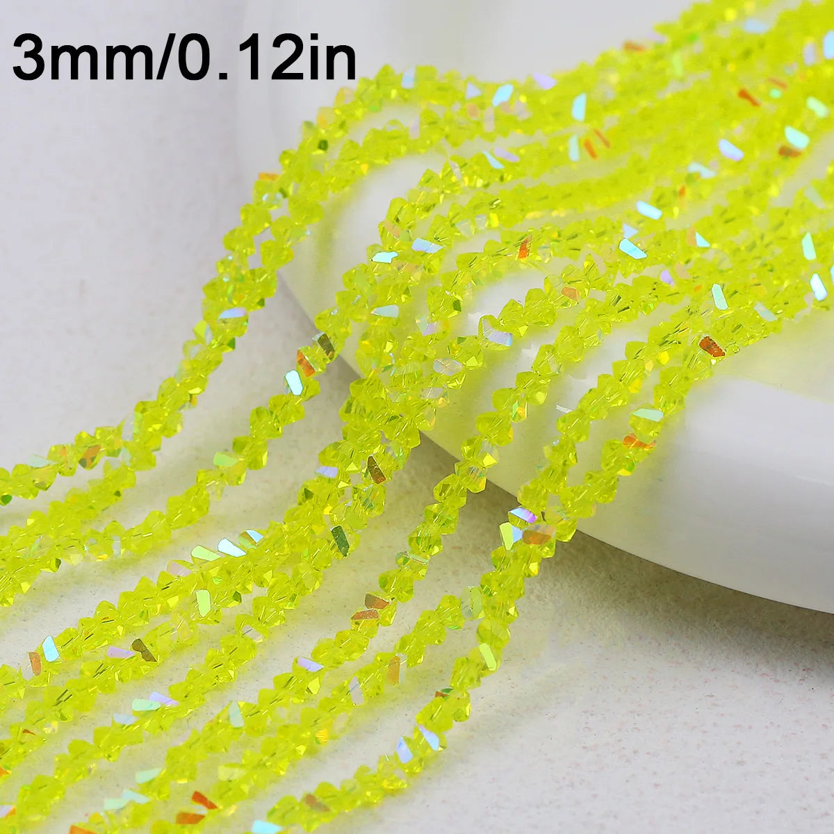 Yellow crystal triangle beads measuring 3mm or 0.12 inches strung together for jewelry making