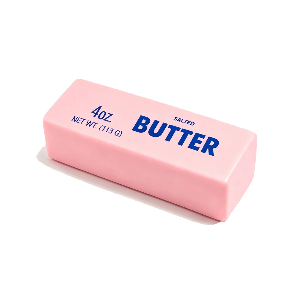A pink butter stick squishy toy labeled 4oz salted butter with the word BUTTER on it.
