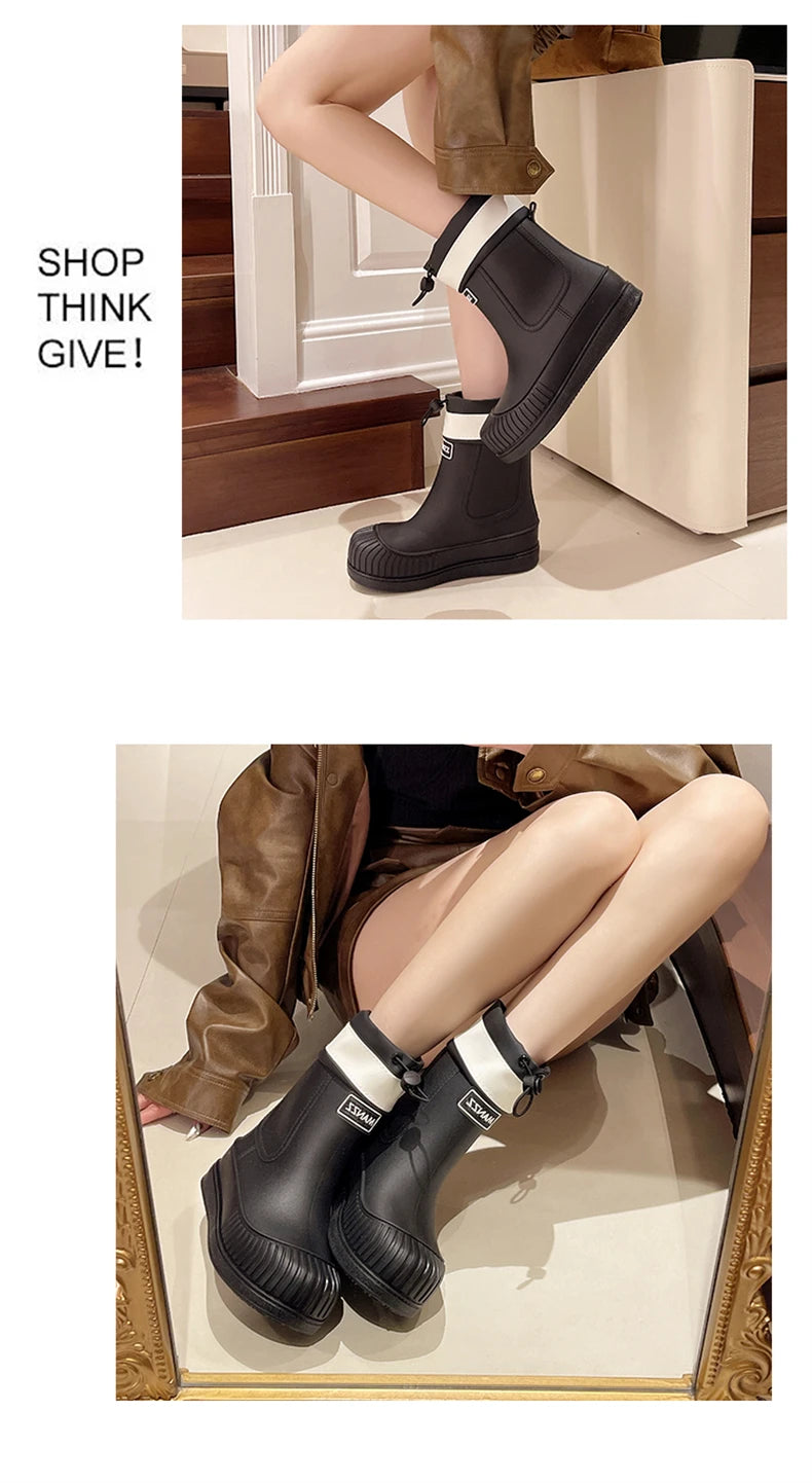 A pair of black waterproof mid-calf rain boots with white trim and non-slip soles shown on a person's leg.