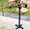 A silver diecast construction crane model toy set mounted on a black stand, set against a blurred outdoor background.