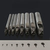 A row of precision leather hole punches for belts and crafting tools displayed on a dark surface.