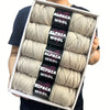 A pack of five balls of light beige alpaca wool yarn for knitting and crochet projects.