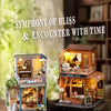 A detailed wooden miniature dollhouse kit featuring a coffee shop and garden house with LED lighting.