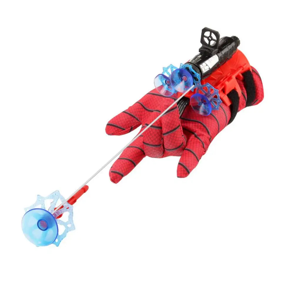 A hand wearing a red glove is holding a device with blue web-shooting elements.