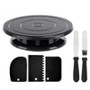 A black cake decorating kit featuring a rotating turntable, spatulas, and scrapers.
