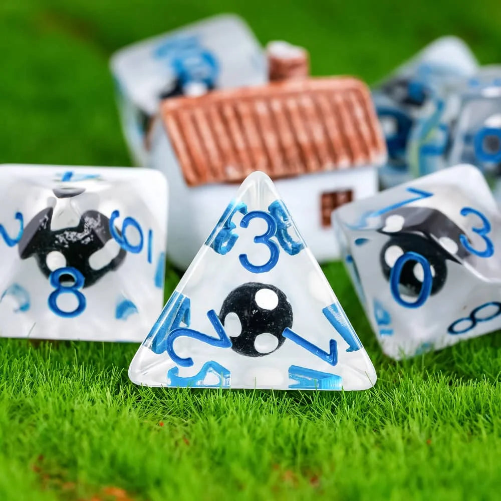 A set of polyhedral dice featuring a mushroom theme, resting on green grass.