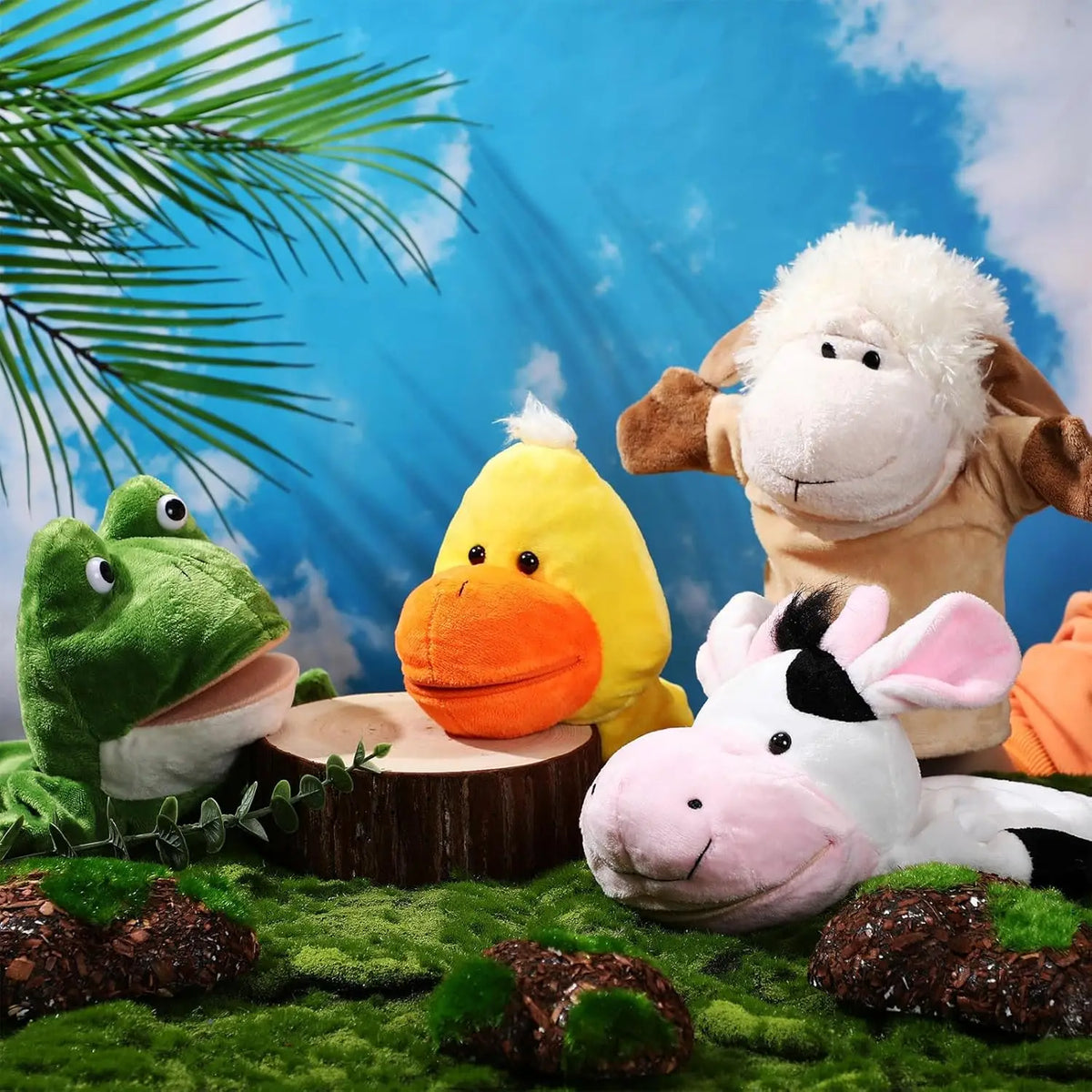 A set of soft plush animal hand puppets featuring a green frog, a yellow duck, and a white donkey against a blue sky backgrou