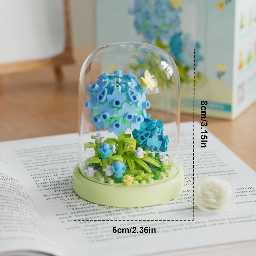 A clear glass jar filled with green flower building blocks and blue flowers.