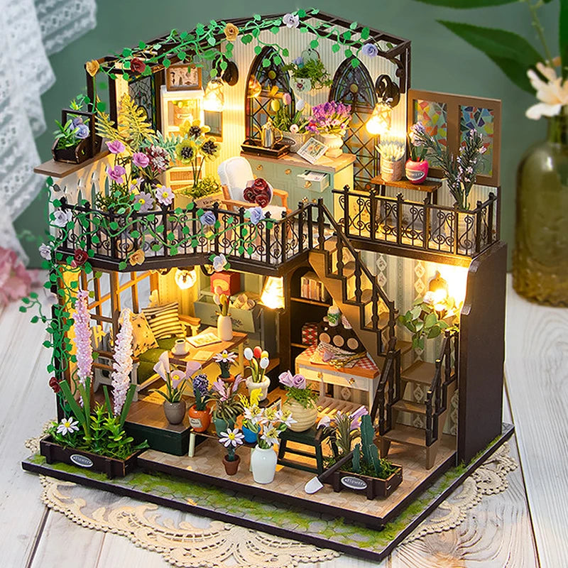 A detailed DIY miniature dollhouse kit featuring furniture, plants, and warm lighting.