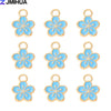 A set of 15 enamel flower and cherry charms for jewelry making, featuring light blue and gold accents.