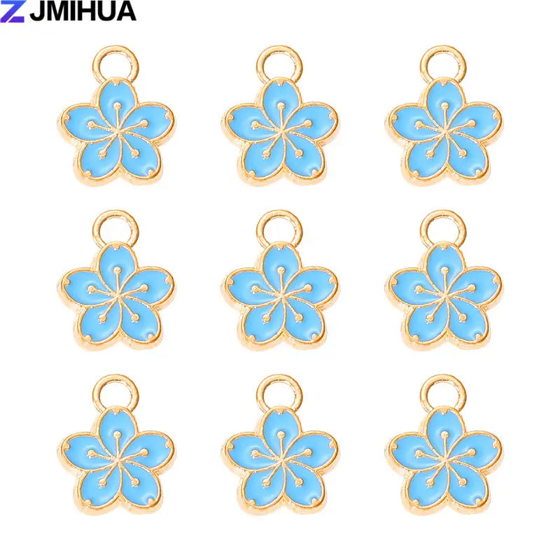 A set of 15 enamel flower and cherry charms for jewelry making, featuring light blue and gold accents.