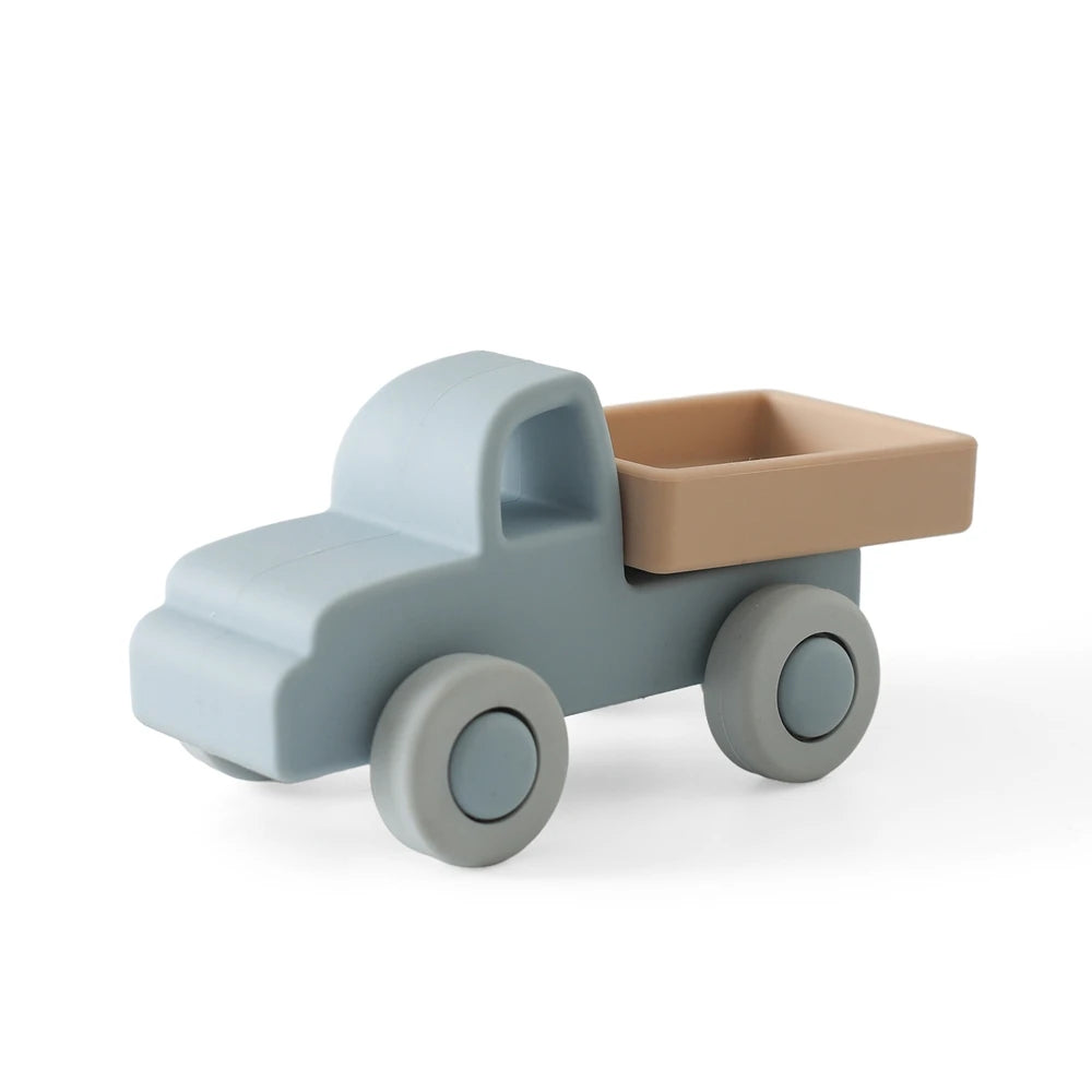 A light blue silicone toy car with a tan tray and wheels, designed for toddlers.