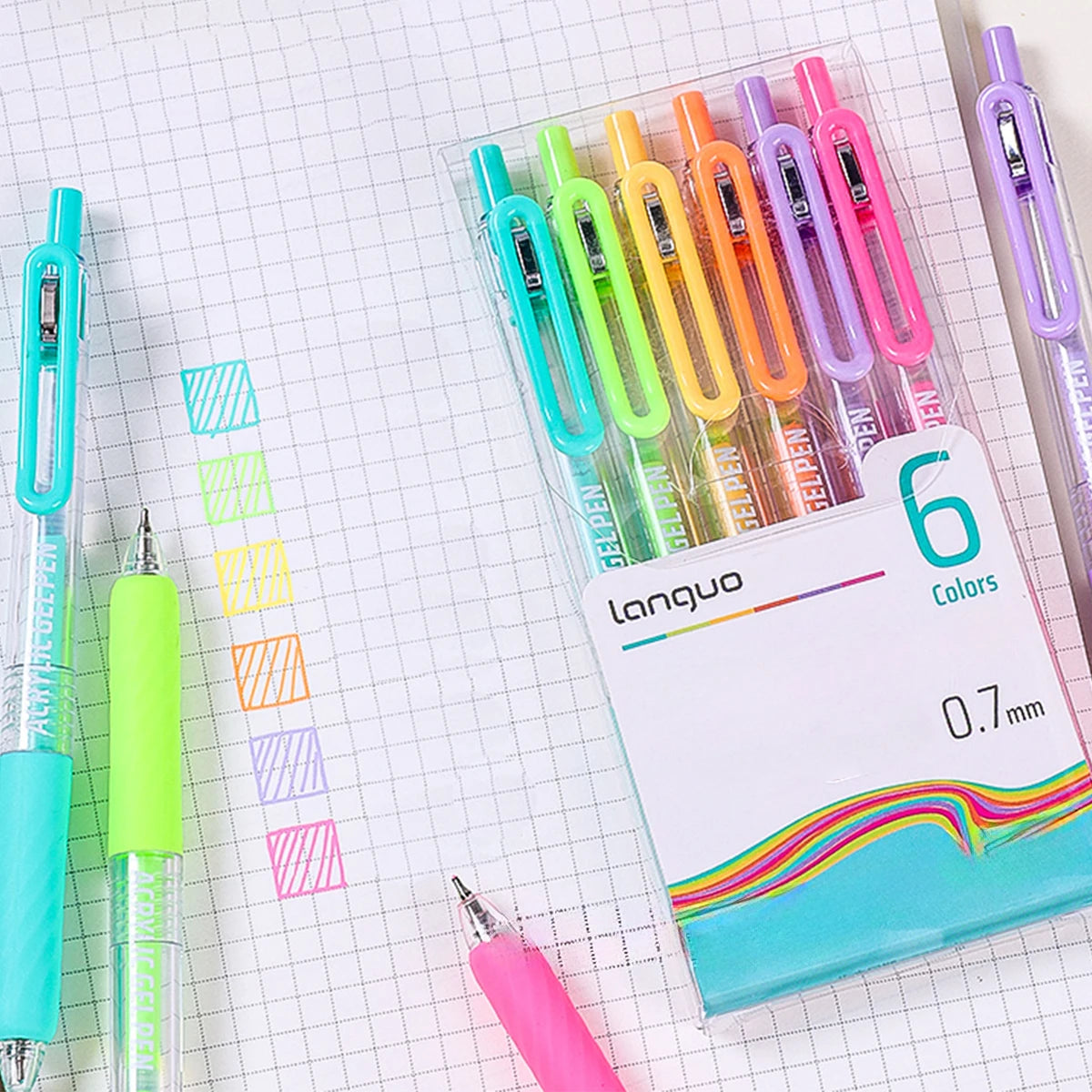 A pack of six colorful retractable gel pens with 0.7mm tips displayed on a grid paper background.