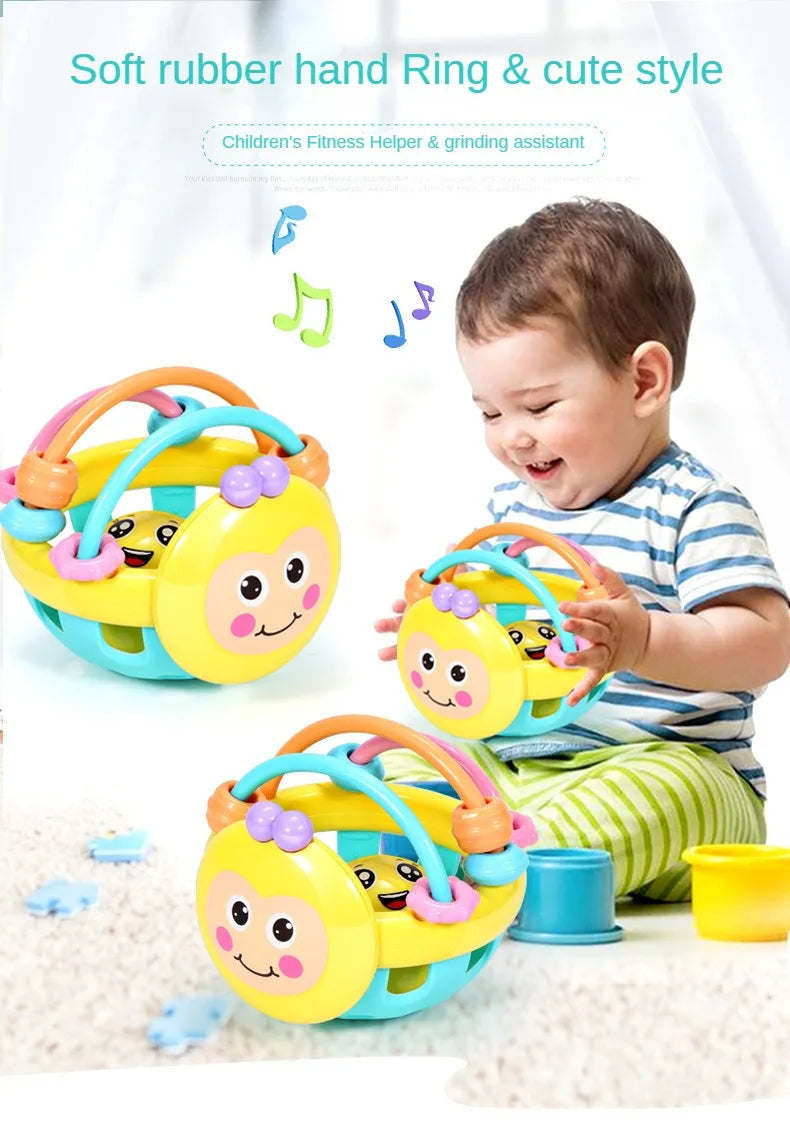 A baby is playing with a yellow and blue soft rubber hand ring and cute style fitness helper toy.