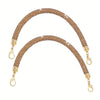 A gold-toned purse strap adorned with sparkling rhinestones.
