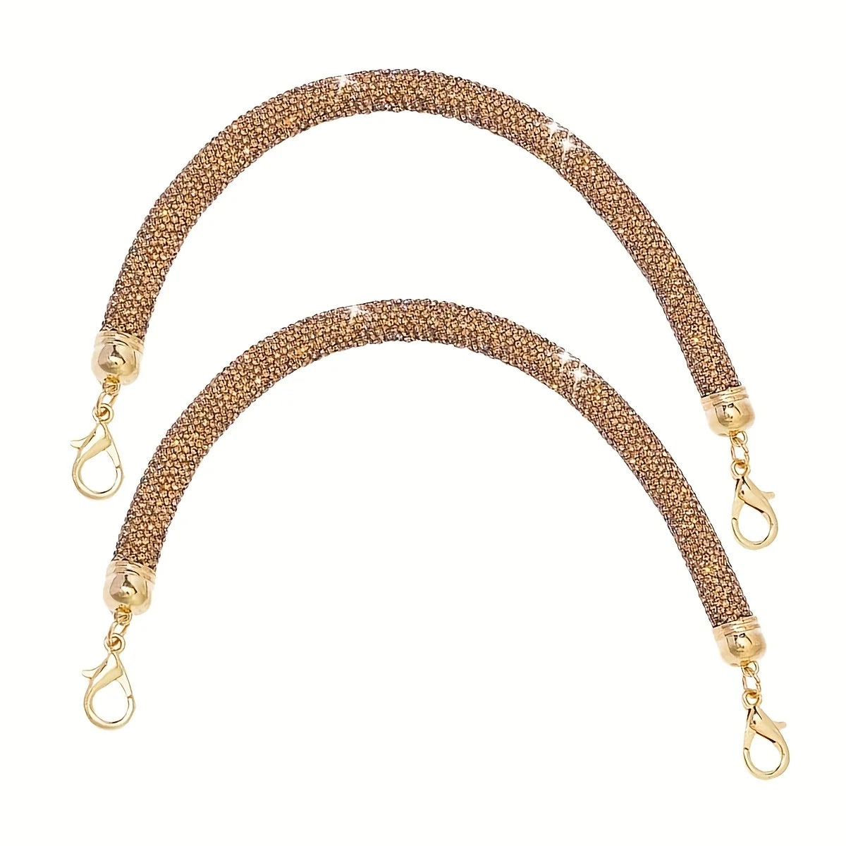 A gold-toned purse strap adorned with sparkling rhinestones.