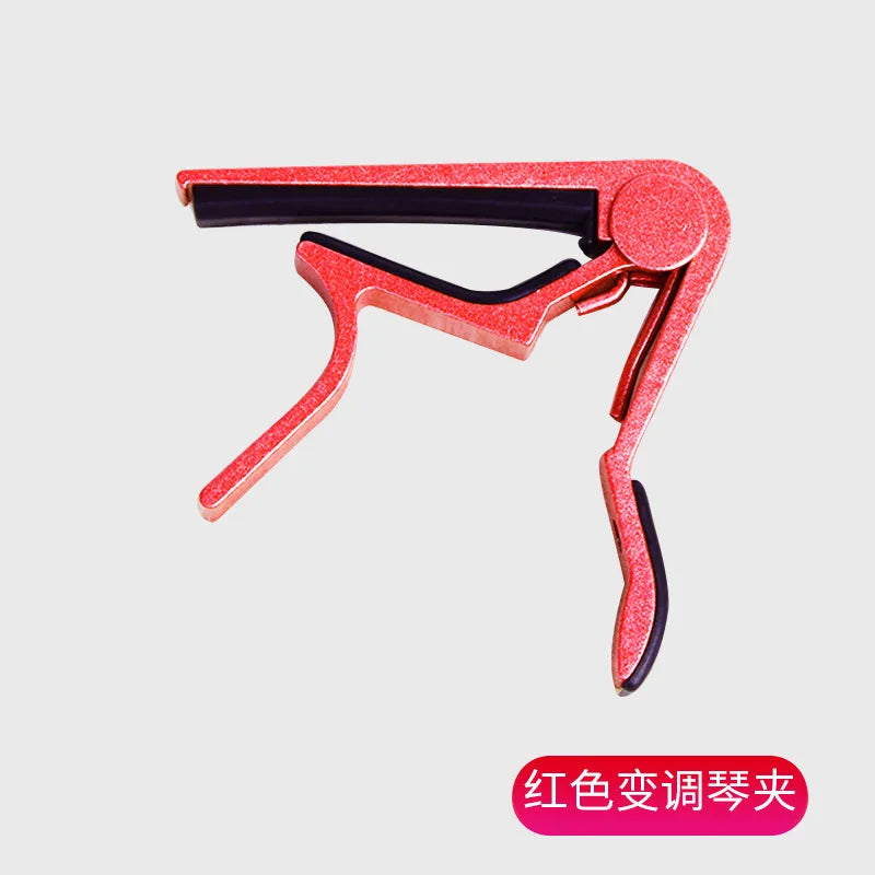 A red aluminium alloy quick-release guitar capo with a pink finish.